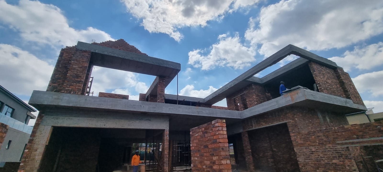 Roof structure and brickwork of a luxury home nearing completion